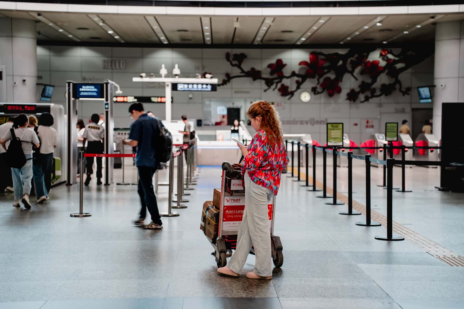 A traveller with luggage in an airport terminal